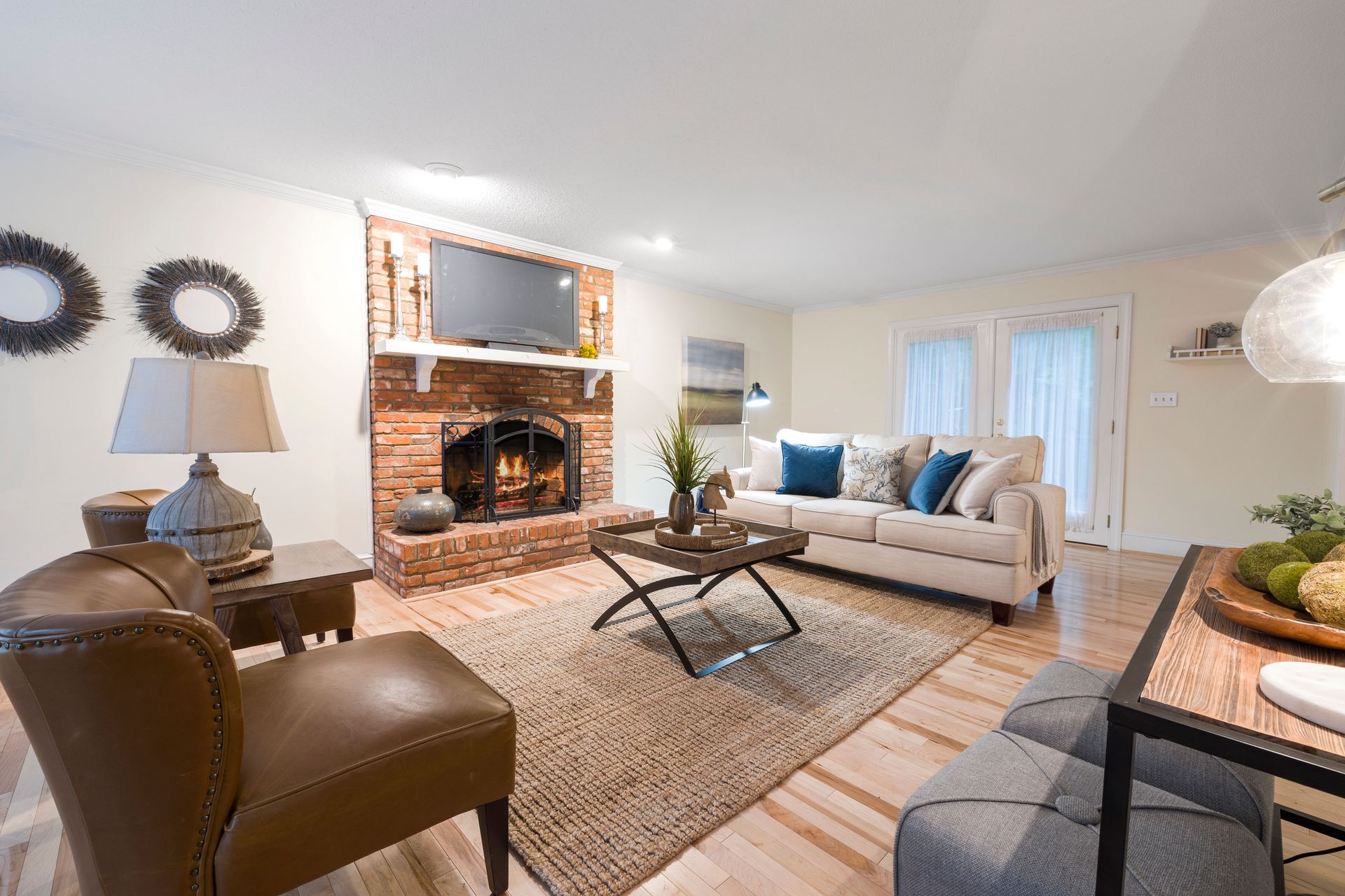 Inviting living room featuring cozy seating, brick fireplace, and stylish decor.